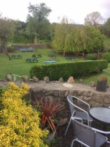 a garden with a table and chairs and a park at 1 Bed cottage The Stable at Llanrhidian Gower with sofa bed for additional guests in Swansea