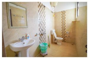 a bathroom with a sink and a toilet at Shivalik River Retreat in Almora +79 photos