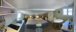 a small bedroom with a bed and a kitchen at Enjoy Antibes in Antibes