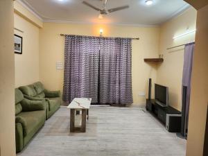 a living room with a couch and a television at Burhani Manzil in Udaipur