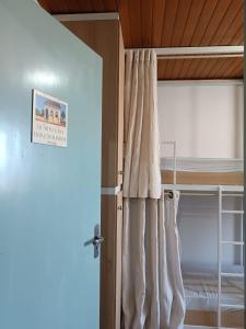 a bedroom with a bunk bed with white curtains at Lapa Hostel - PARANÁ in Lapa