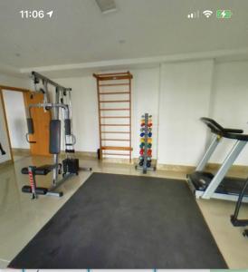 a room with a gym with a treadmill and weights at Vista Panorâmica com piscina in Porto Alegre