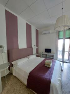 Postel nebo postele na pokoji v ubytování Giove Rooms
