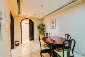 - une salle à manger avec une table et des chaises en bois dans l'établissement OYO 154 Bait AL Marmar Hotel, à Sohar