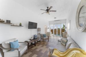 a living room with a couch and a ceiling fan at Casa Loba Suite 2 at 413 with private pool in Rincon