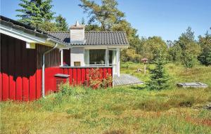 een rood-wit huis in het midden van een veld bij Amazing Home In Fjerritslev With Wifi in Torup Strand