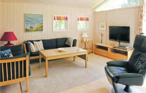 a living room with a couch and a tv at Amazing Home In Fjerritslev With Wifi in Torup Strand