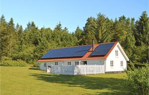 a white barn with solar panels on its roof at Beautiful Home In Brovst With 3 Bedrooms And Wifi in Brovst