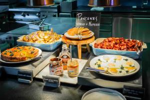 a buffet with different types of food on display at Canopy by Hilton Reykjavik City Centre in Reykjavík