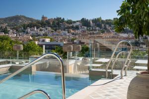 a swimming pool with a view of a city at Barceló Carmen Granada in Granada