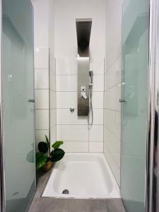 a bathroom with a shower and a bath tub at Fewo am Wiesengrund in Lüdinghausen