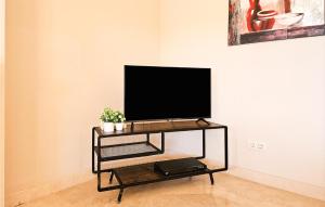 A television and/or entertainment centre at Gorgeous Home In Benahavís With Wifi