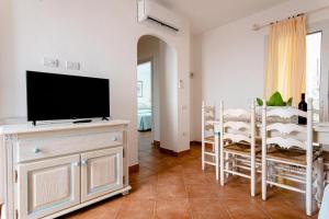 a living room with a flat screen tv on a dresser at Superb Le Residenze del Golfo di Orosei num2192 in Orosei