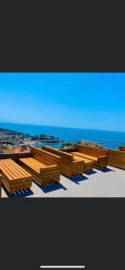 a group of wooden benches sitting on top of a building at Apartments Tati in Ulcinj