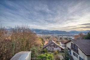 a view of a town with mountains in the distance at L'Ecrin Secret des Capucins in Meylan