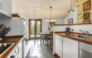 a kitchen with a sink and a table at Stunning Home In Ebeltoft With 3 Bedrooms, Sauna And Wifi in Ebeltoft