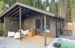a small house with a deck and a swimming pool at Cozy Home In Stordal With House A Mountain View in Stordal