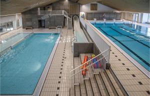 a large indoor swimming pool with a swimming pool at Hytte 14 in Thyborøn