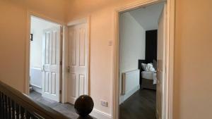 a hallway with a mirror and a room with a bed at ANFIELD PLACE TO STAY in Liverpool