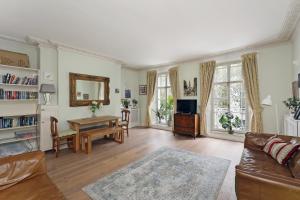a living room with a couch and a table at Covent Garden Superior Two Bedroom Aparment on Strand in London