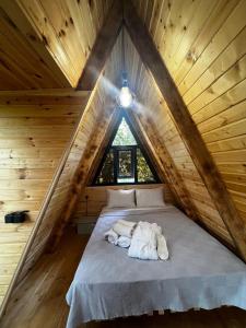 a bedroom with a bed in a wooden attic at La'Familia in Batumi