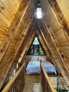 a bedroom in a log cabin with a bed at La'Familia in Batumi