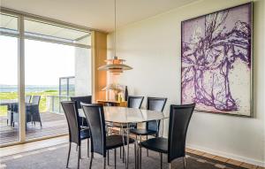 a dining room with a table and chairs at Amazing Apartment In Ebeltoft With House Sea View in Ebeltoft