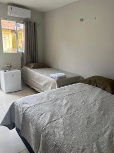 Een bed of bedden in een kamer bij Pousada Do Sol