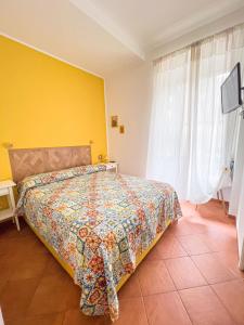 a bedroom with a bed with a yellow wall at Giallo Napoli in Naples