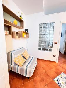 a small room with a bed and a window at Giallo Napoli in Naples