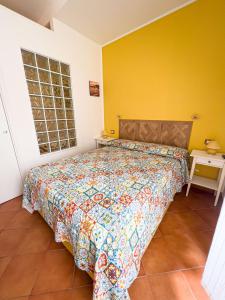a bedroom with a bed and a yellow wall at Giallo Napoli in Naples