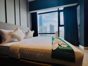 a bedroom with a bed with a large window at The Axon Suites Bukit Bintang By Cozy Stay in Kuala Lumpur
