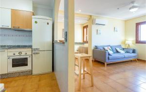 een keuken en een woonkamer met een koelkast bij Beautiful Apartment In Santa Pola With Outdoor Swimming Pool in Santa Pola