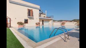 a swimming pool in the backyard of a house at Stylish Residence Le Fontane no2503 in Villasimius