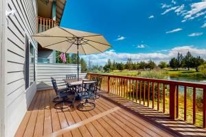 a wooden deck with a table and an umbrella at The Golden Pheasant in Redmond