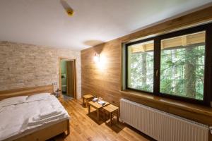 a bedroom with a bed and a large window at Complex Sofia&Veruța in Baia-Sprie