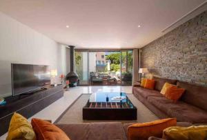 sala de estar con sofá y TV en Luxury Villa 3+1 BD & pool/jacuzzi/golf/beach en Vale do Lobo