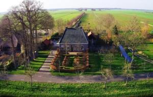 an aerial view of a house in a field at Vakantiewoning Opa's Huisje in Ruinerwold