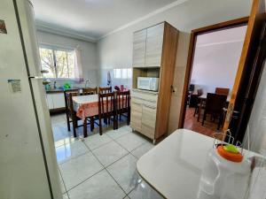 een keuken en een woonkamer met een tafel en een eetkamer bij Básico e Aconchegante in Itajubá