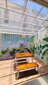 a room with a table and a mural on the wall at Omah Dixy Family Homestay by FH Stay in Bantul