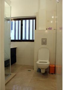 a bathroom with a toilet and a glass shower at Terrasse vue mer, plage à 100m, 3 pièces in Tel Aviv