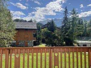 a wooden fence in front of a house at Appartement proche des pistes avec terrasse sud - FR-1-411-687 in Les Allues