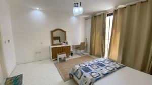 a bedroom with a bed and a desk and a mirror at 2-Bedrooms TownHouse Villa dxb Gplus1 in Dubai +19 photos