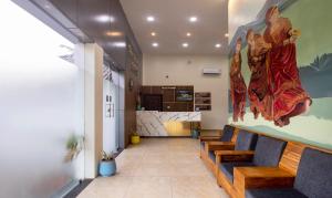 a lobby with benches and a painting on the wall at Treebo Trend The Rove in Madikeri