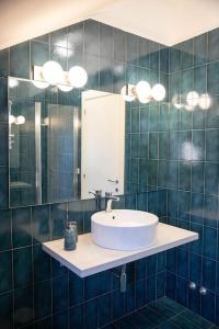 a bathroom with a sink and a mirror at Casa Azul Apartment in Porto San Giorgio +51 photos