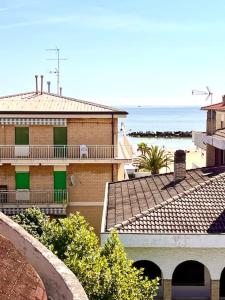a view of a building with the ocean in the background at Casa Azul Apartment in Porto San Giorgio