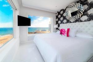 A bed or beds in a room at Lani's Suites de Luxe - Adults Only