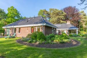 a brick house with a garden in the yard at B&B Schipborg in Zuidlaren
