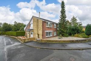 a brick house with a driveway in front of it at Luxurious & Tranquil Riverside Getaway in Great Harwood