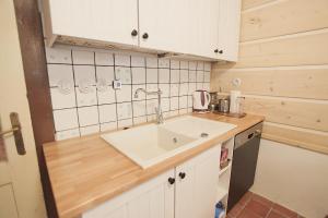 a kitchen with a sink and a counter top at Roubenka U Andělů, Šumava in Kašperské Hory